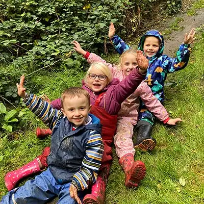 reception children sliding down the mud slide autumn 2021